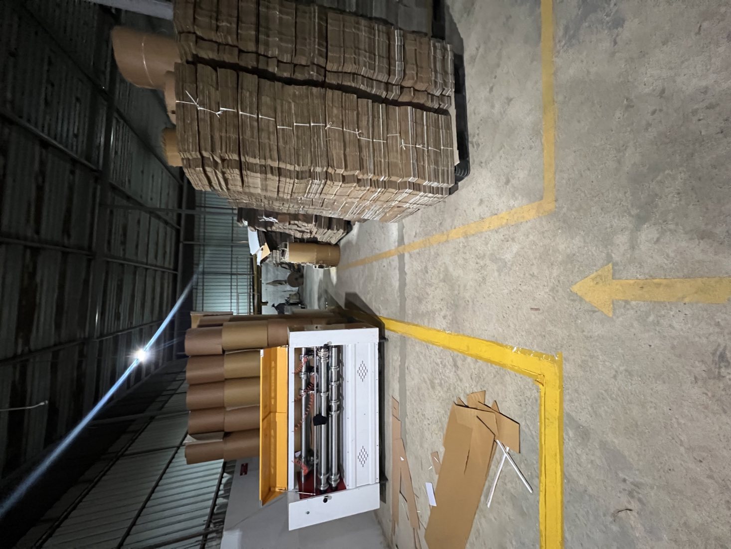 Converting machine with pallets of finished flat cartons at Propack Converters